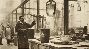 Making money: pots of liquid metal being handled in the melting room by English Photographer